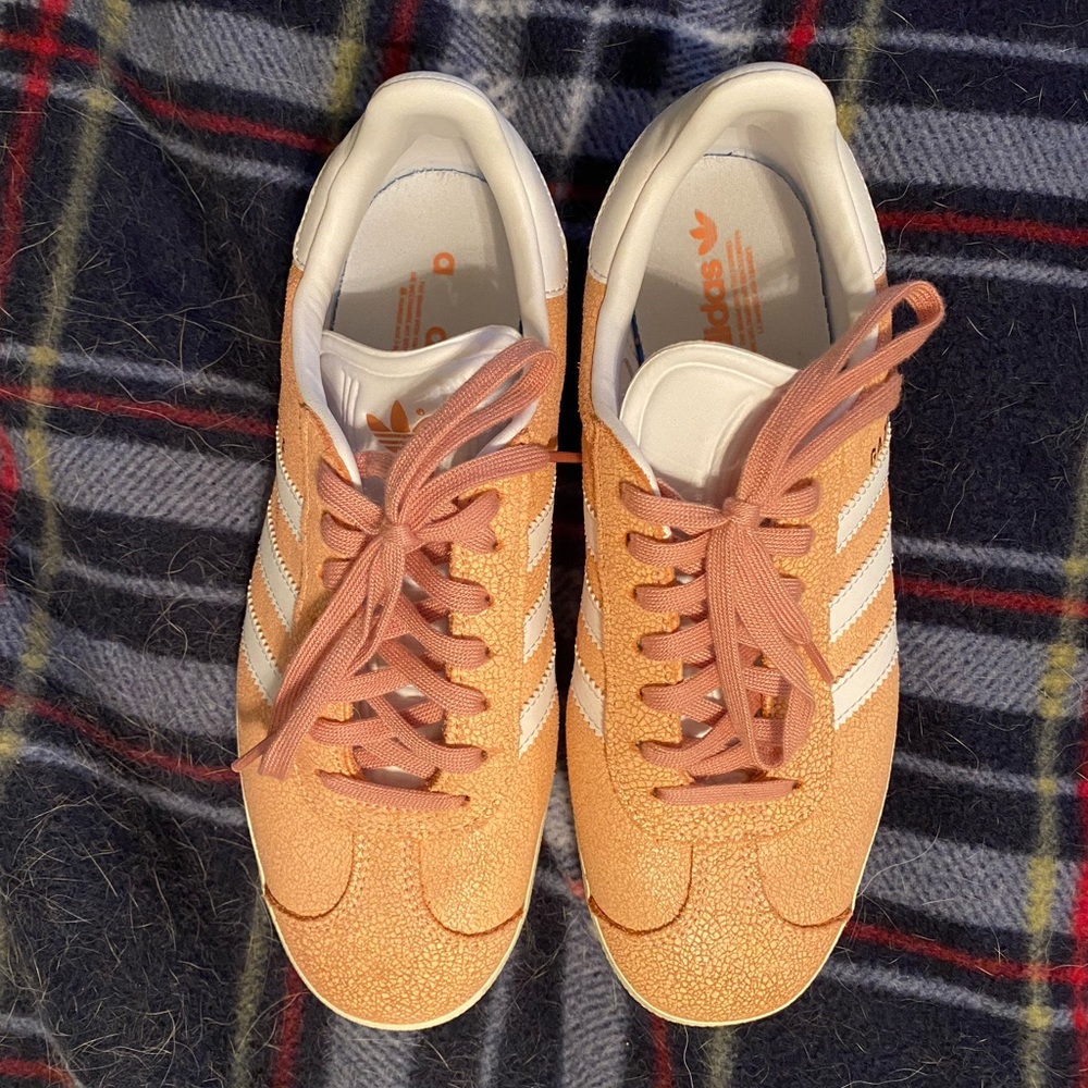 Salmon colored Adidas shoes
